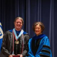 Provost poses for picture with man